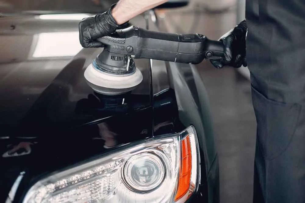 A man guiding how to wax car properly